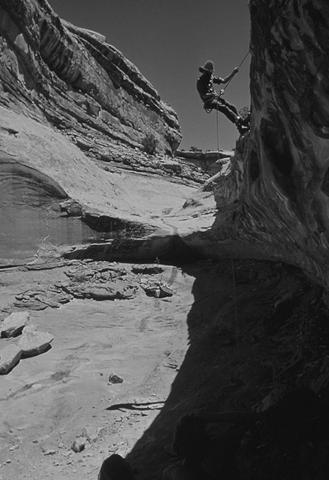 A man digs a six-foot metaphor while climbing a completely separate metaphor.